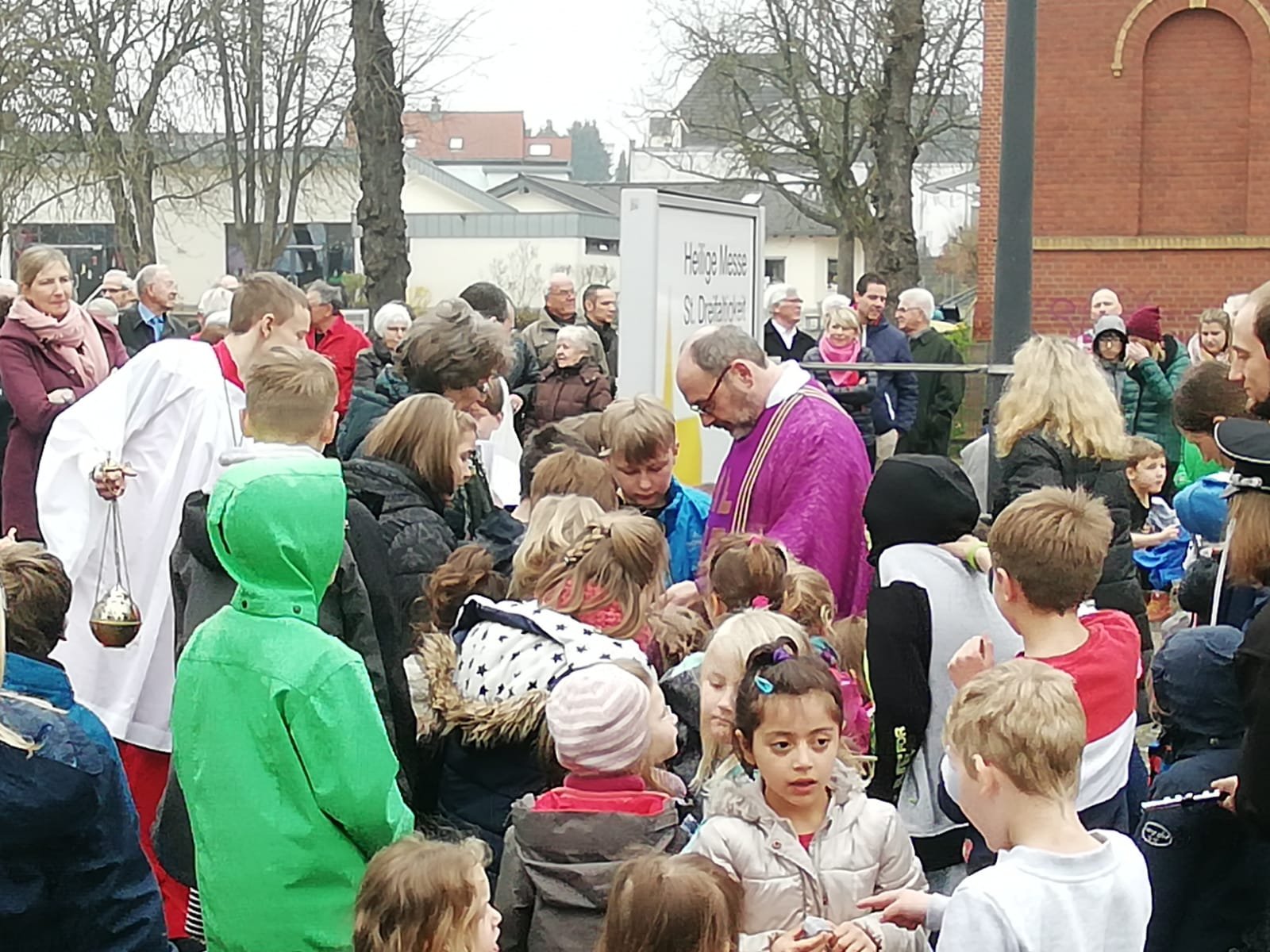 Pfarrer Wahlen umringt von Kindern auf dem Kirchplatz von St. Dreifaltigkeit (c) Stefan Groß